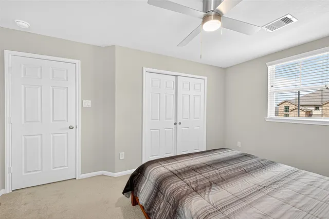 a bedroom with a bed and a desk