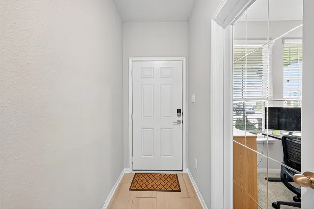 a view of a workspace with furniture and a window
