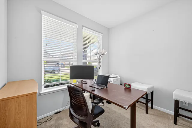 a view of a dining room with furniture and window