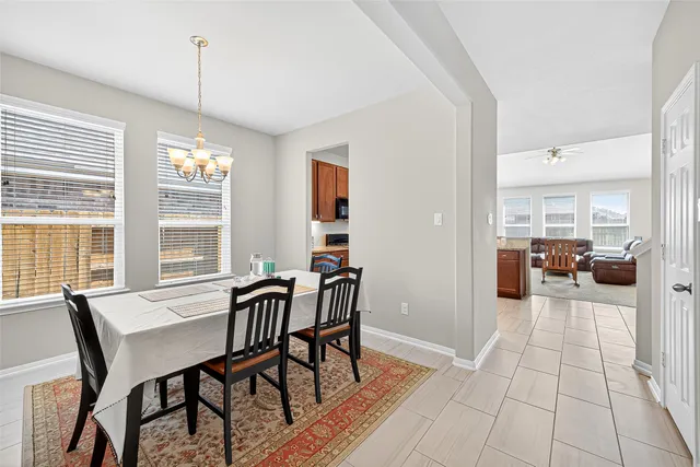 a living room with furniture a flat screen tv and a window