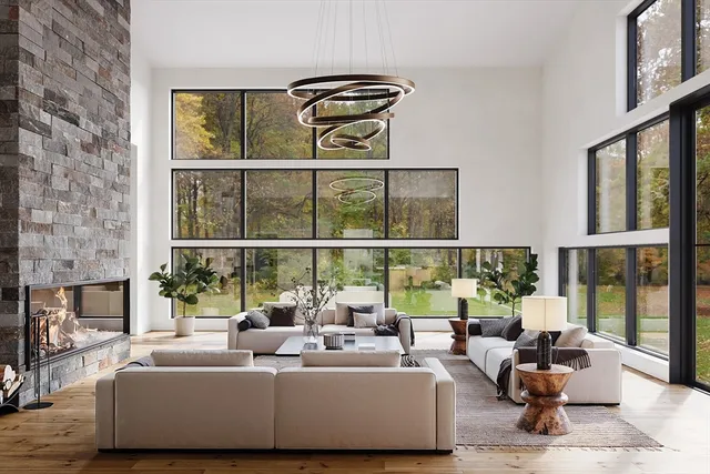 a living room with furniture and floor to ceiling windows