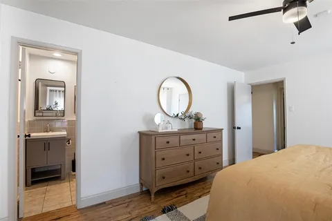a bedroom with a bed and a dresser