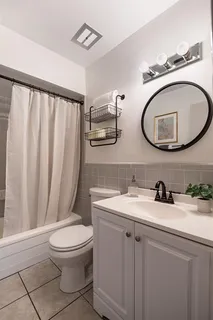 a bathroom with a toilet a sink and mirror