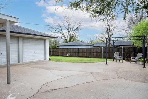 a view of a house with a backyard and a tree