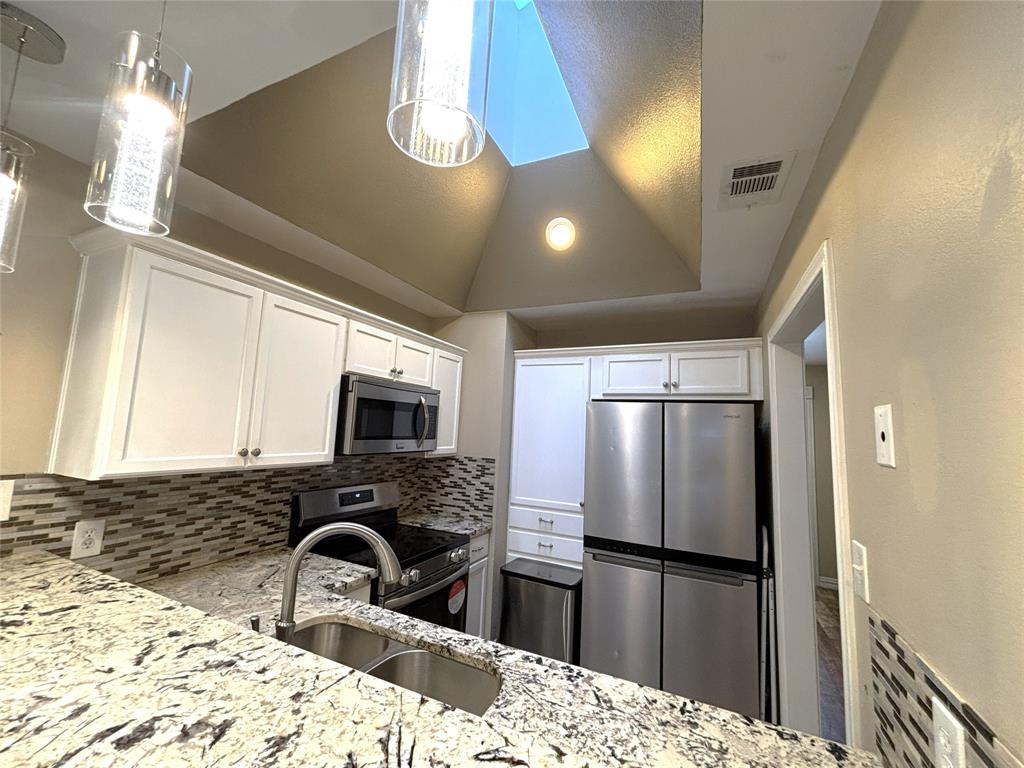 9461 Timberleaf Drive Dallas, TX 75243 - Photo 15 of 32 a kitchen with a refrigerator sink and microwave