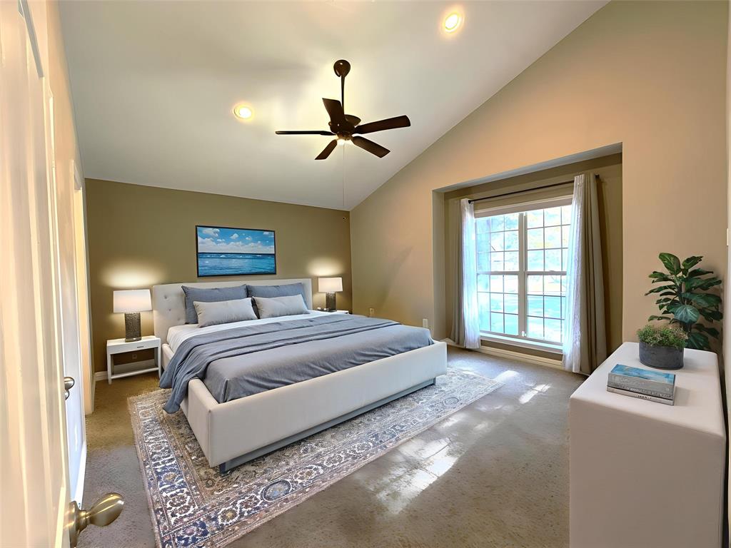 9461 Timberleaf Drive Dallas, TX 75243 - Photo 18 of 32 a spacious bedroom with a large bed and a chandelier