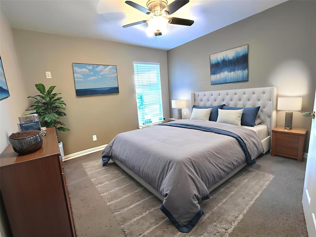 9461 Timberleaf Drive Dallas, TX 75243 - Photo 23 of 32 a bedroom with a bed and a potted plant