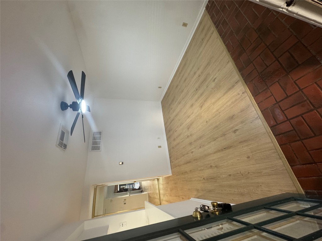 a view of empty room with wooden floor