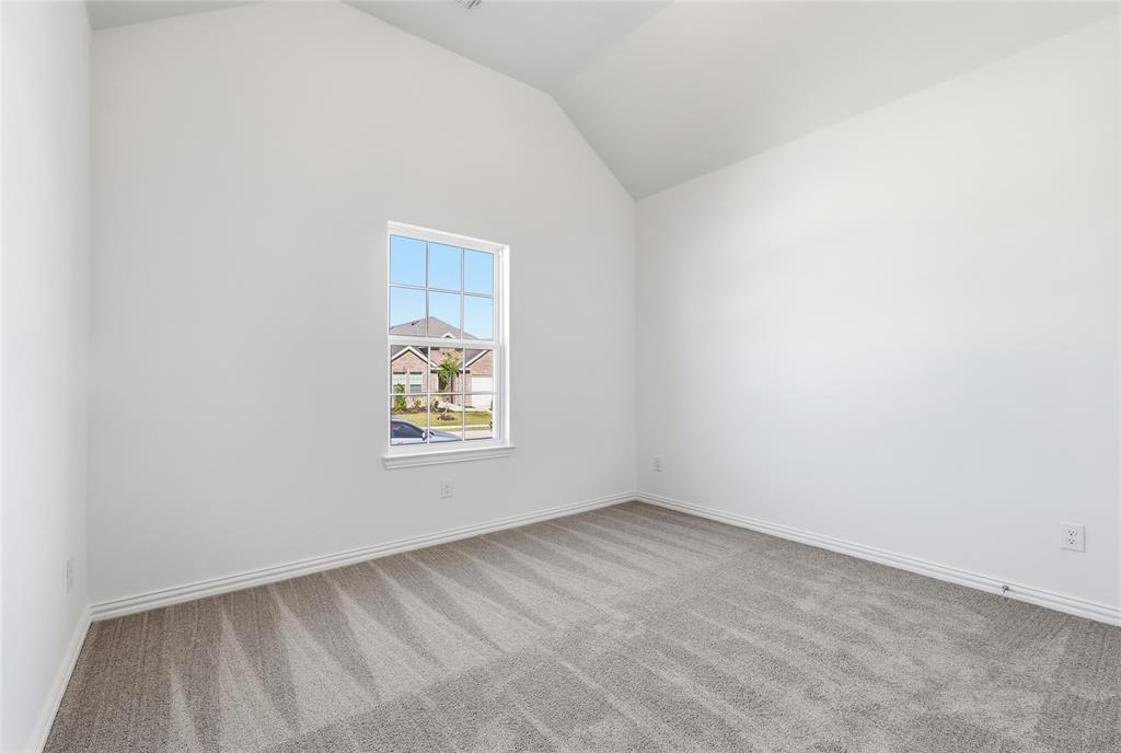 2529 Rivers W Road Anna, TX 75409 - Photo 3 of 40 Vaulted ceiling room featuring a single-pane window with grids, light gray carpet, white walls, and white baseboards