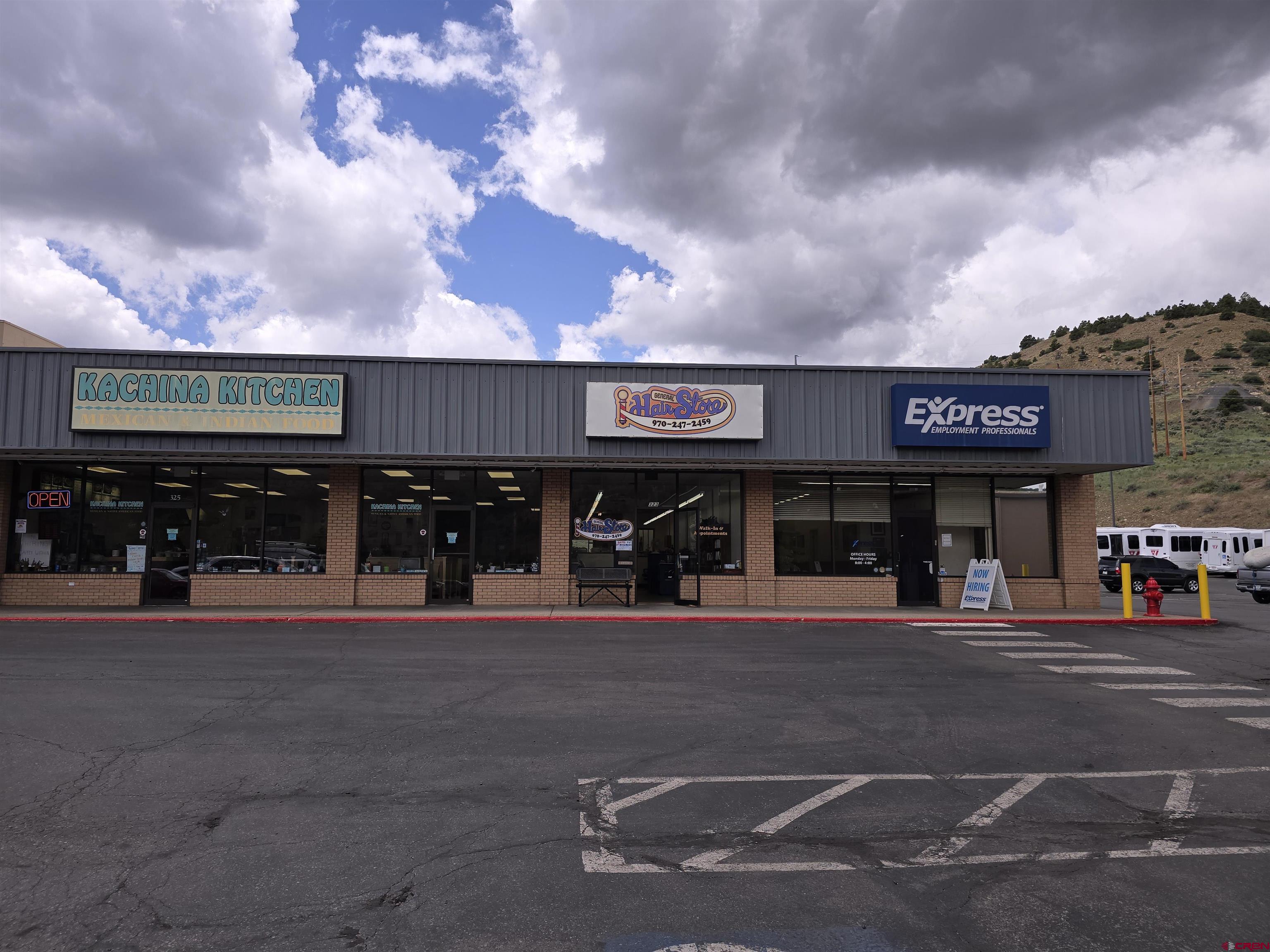 323 South Camino Del Rio, Unit SUITE L ( FORMER GENERAL HAIR CARE ) Durango, CO 81303 - Photo 2 of 9 a front view of a multi story building with retail shops and traffic signal