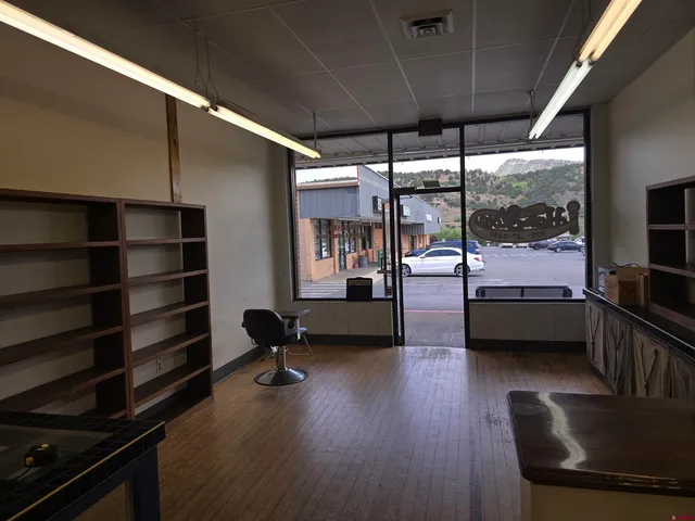 a bedroom with furniture wooden floor and window