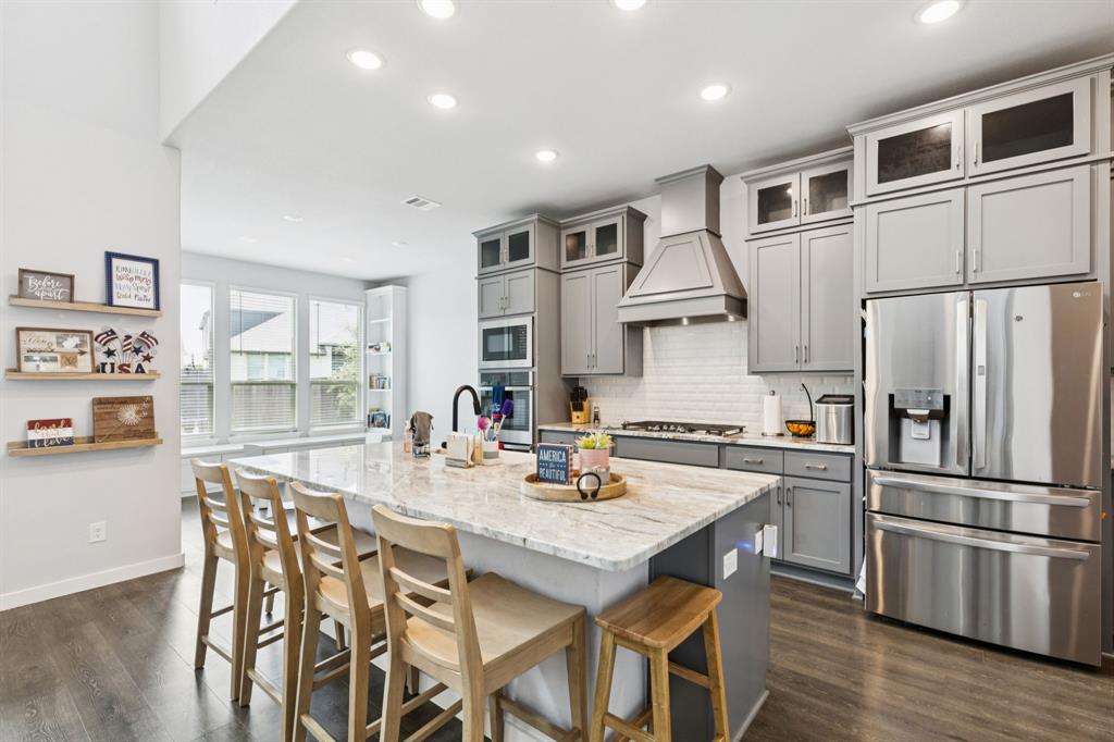 2805 Tower Road Mansfield, TX 76063 - Photo 11 of 33 a kitchen with stainless steel appliances granite countertop a dining table chairs refrigerator and cabinets