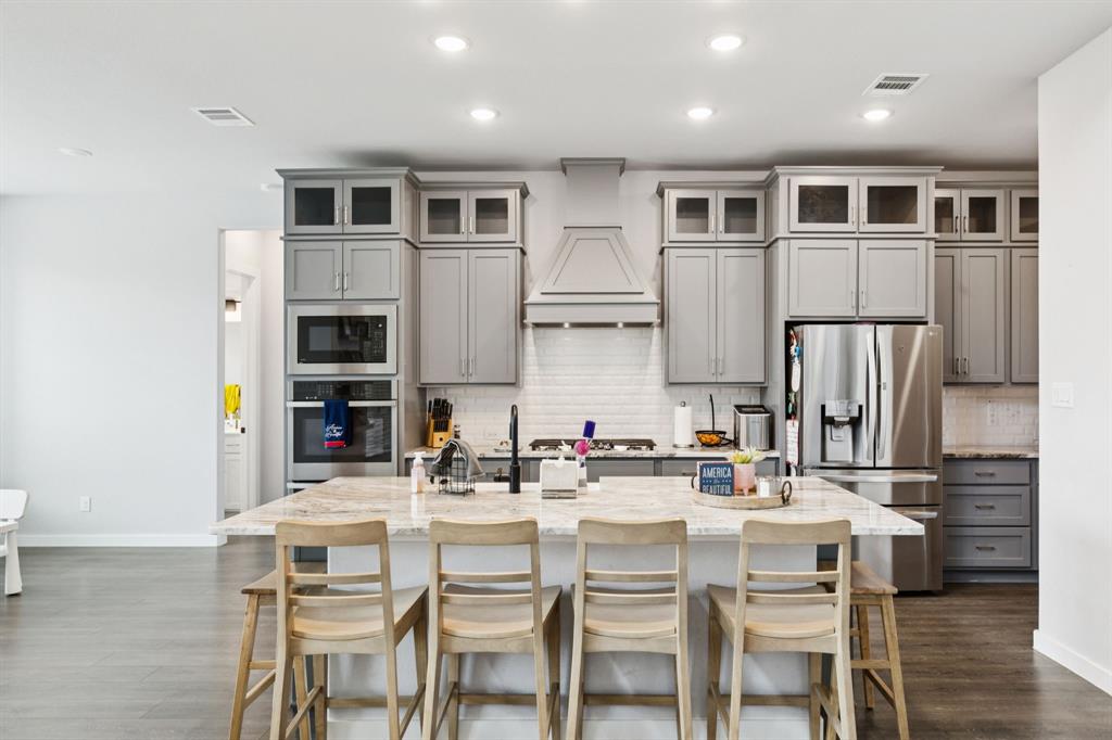 2805 Tower Road Mansfield, TX 76063 - Photo 12 of 33 a dining room with stainless steel appliances kitchen island granite countertop a dining table and chairs