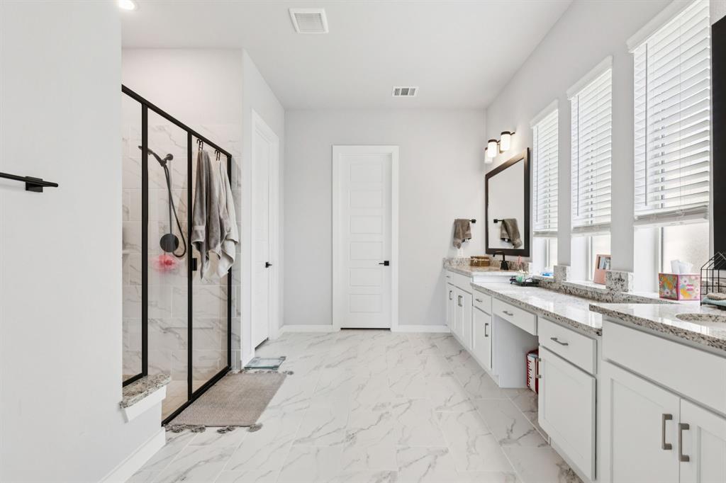 2805 Tower Road Mansfield, TX 76063 - Photo 21 of 33 a large white bathroom with a granite countertop sink mirror and a bathtub