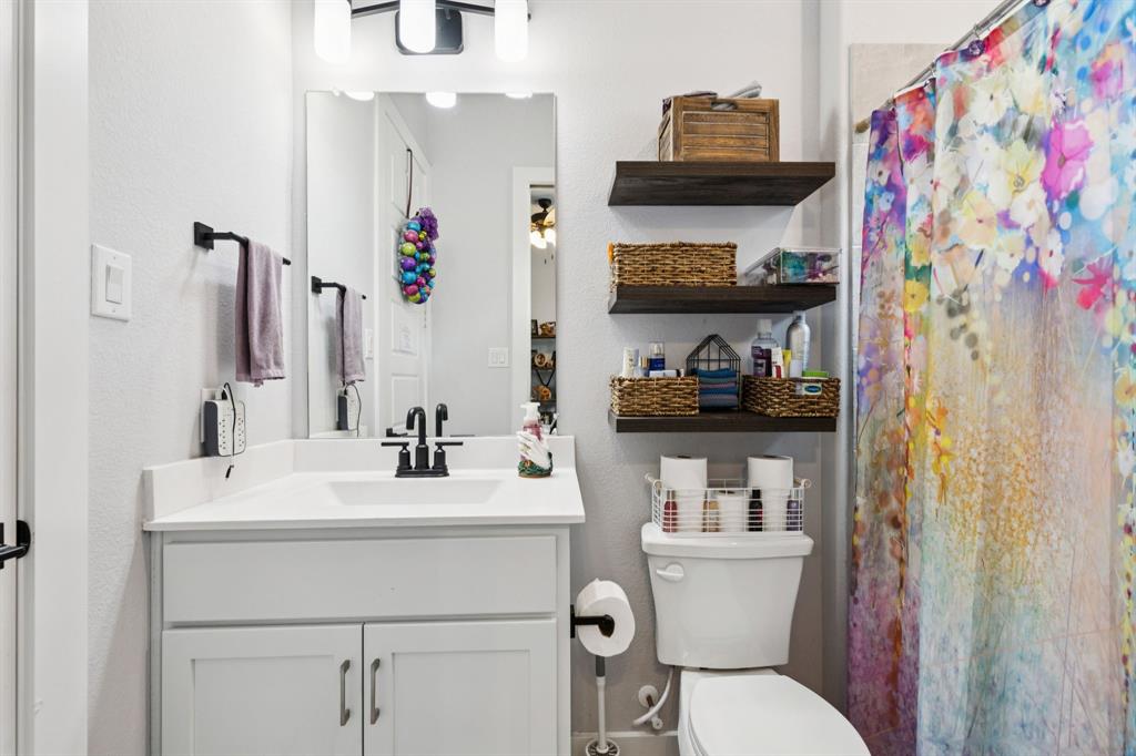 2805 Tower Road Mansfield, TX 76063 - Photo 25 of 33 a bathroom with a sink vanity mirror and toilet