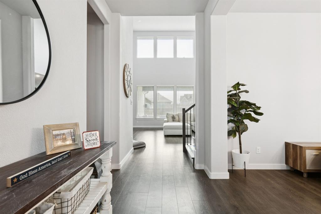 2805 Tower Road Mansfield, TX 76063 - Photo 3 of 33 a view of a hallway with wooden floor windows and a livingroom
