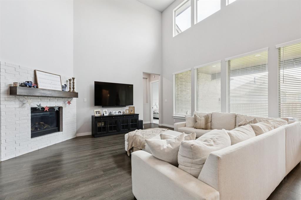 2805 Tower Road Mansfield, TX 76063 - Photo 9 of 33 a living room with furniture a flat screen tv and a fireplace