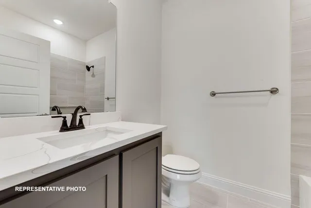 a bathroom with a sink a toilet and mirror