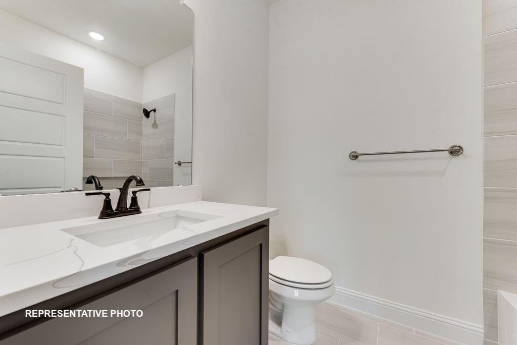 324 Skeen Peak Springtown, TX 76082 - Photo 12 of 14 a bathroom with a sink a toilet and mirror