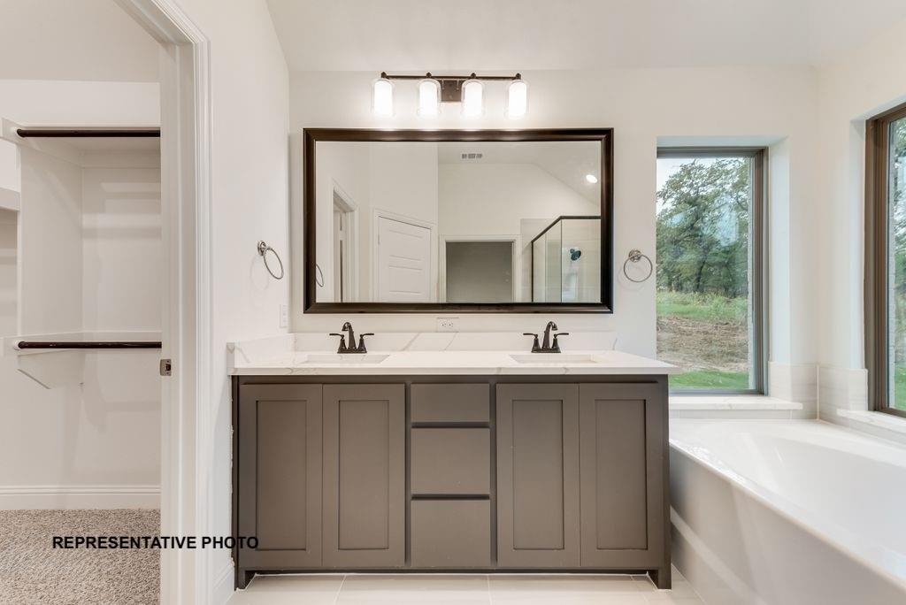 324 Skeen Peak Springtown, TX 76082 - Photo 10 of 14 a bathroom with a sink and a mirror