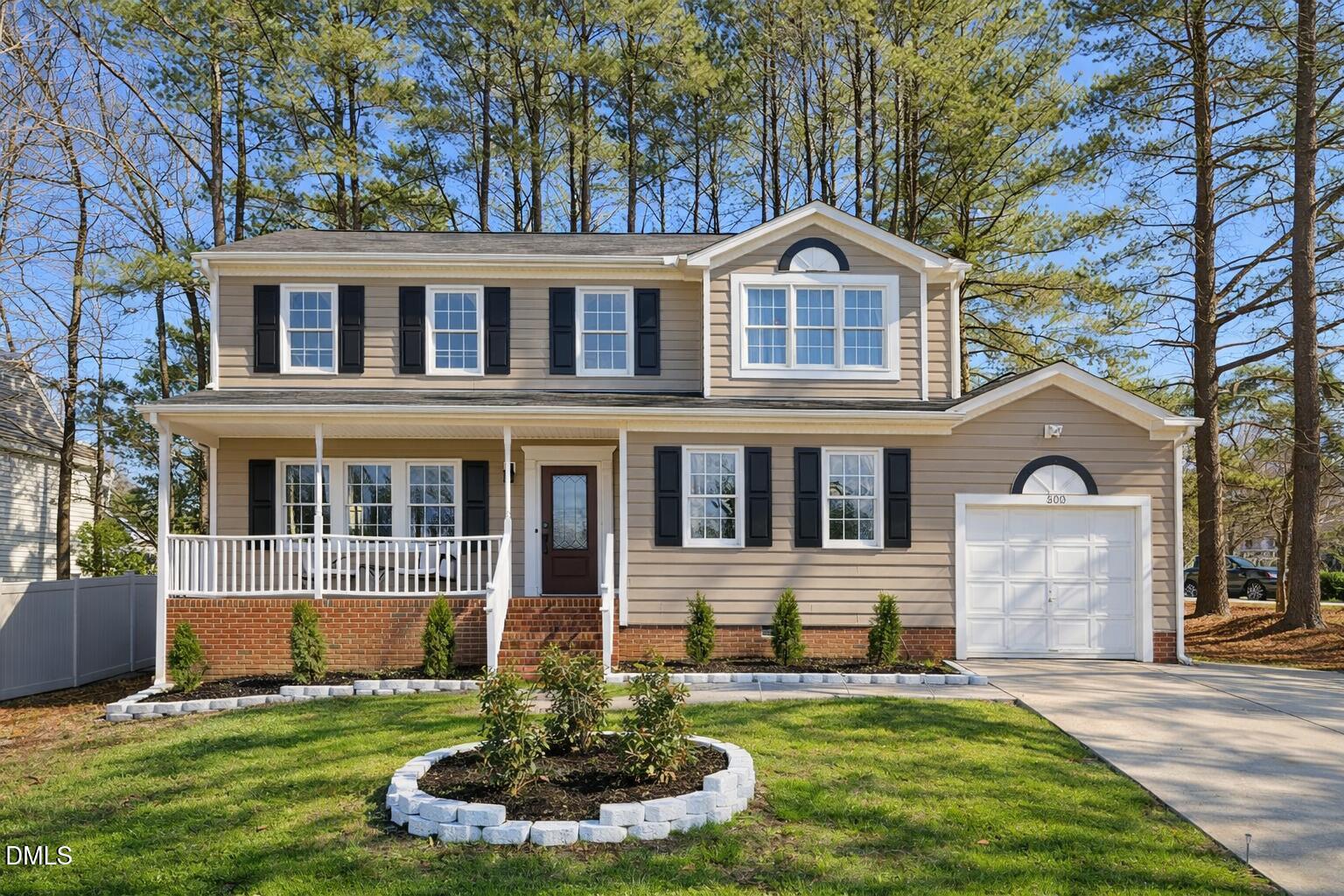 300 Pate Street Apex, NC 27502 - Photo 1 of 33 a front view of a house with a yard and garage
