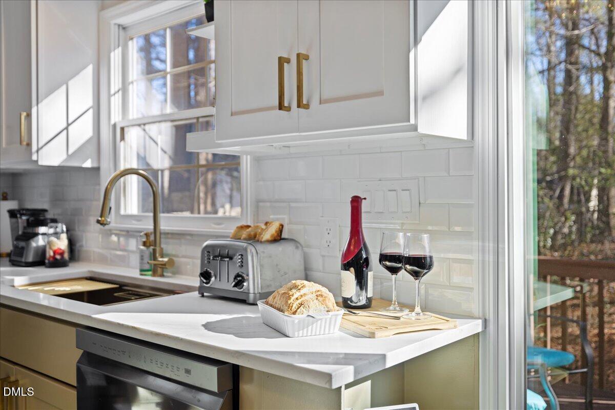300 Pate Street Apex, NC 27502 - Photo 11 of 57 a kitchen with a sink cabinets and appliances
