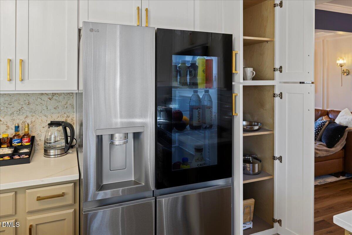 300 Pate Street Apex, NC 27502 - Photo 14 of 57 a kitchen with a refrigerator and cabinets