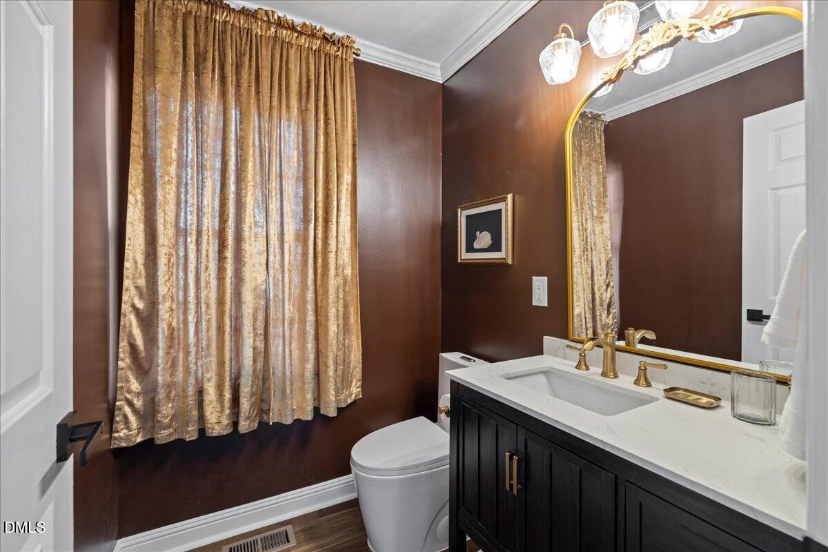 300 Pate Street Apex, NC 27502 - Photo 20 of 57 a bathroom with a granite countertop sink toilet and mirror
