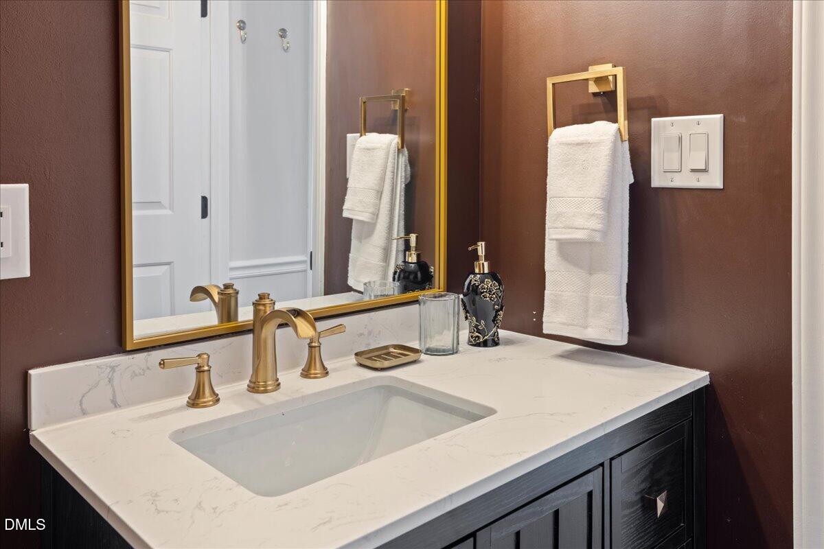 300 Pate Street Apex, NC 27502 - Photo 21 of 57 a bathroom with a sink and a mirror