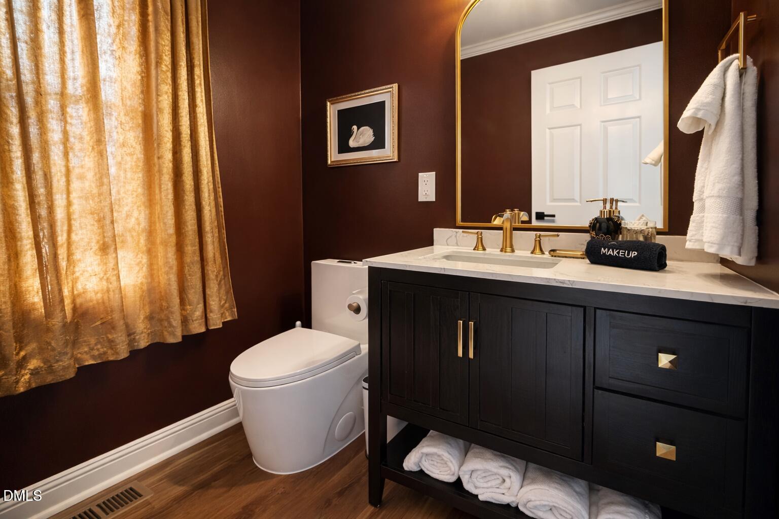300 Pate Street Apex, NC 27502 - Photo 22 of 33 a bathroom with a sink toilet and mirror
