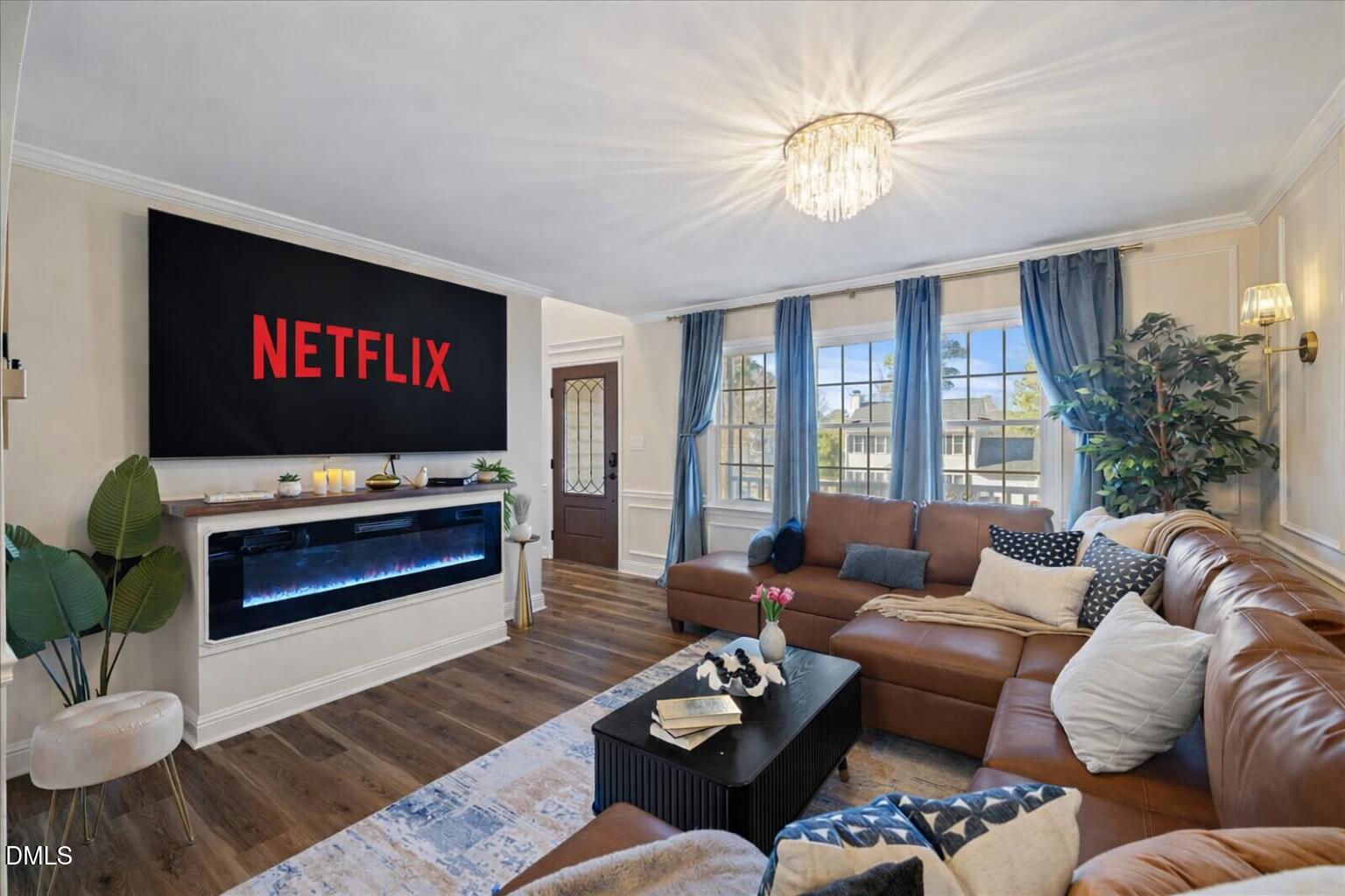 300 Pate Street Apex, NC 27502 - Photo 3 of 57 a living room with furniture a flat screen tv and a large window