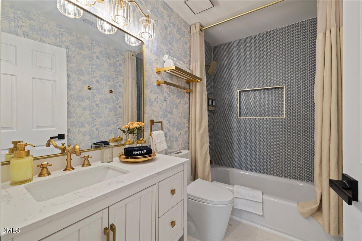 300 Pate Street Apex, NC 27502 - Photo 31 of 57 a bathroom with a sink a toilet and shower