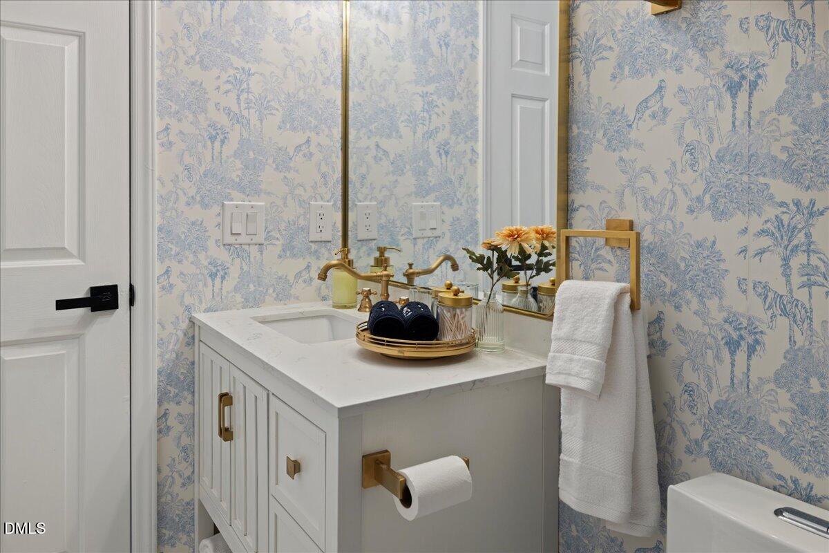 300 Pate Street Apex, NC 27502 - Photo 32 of 57 a bathroom with a sink a toilet and shower curtain