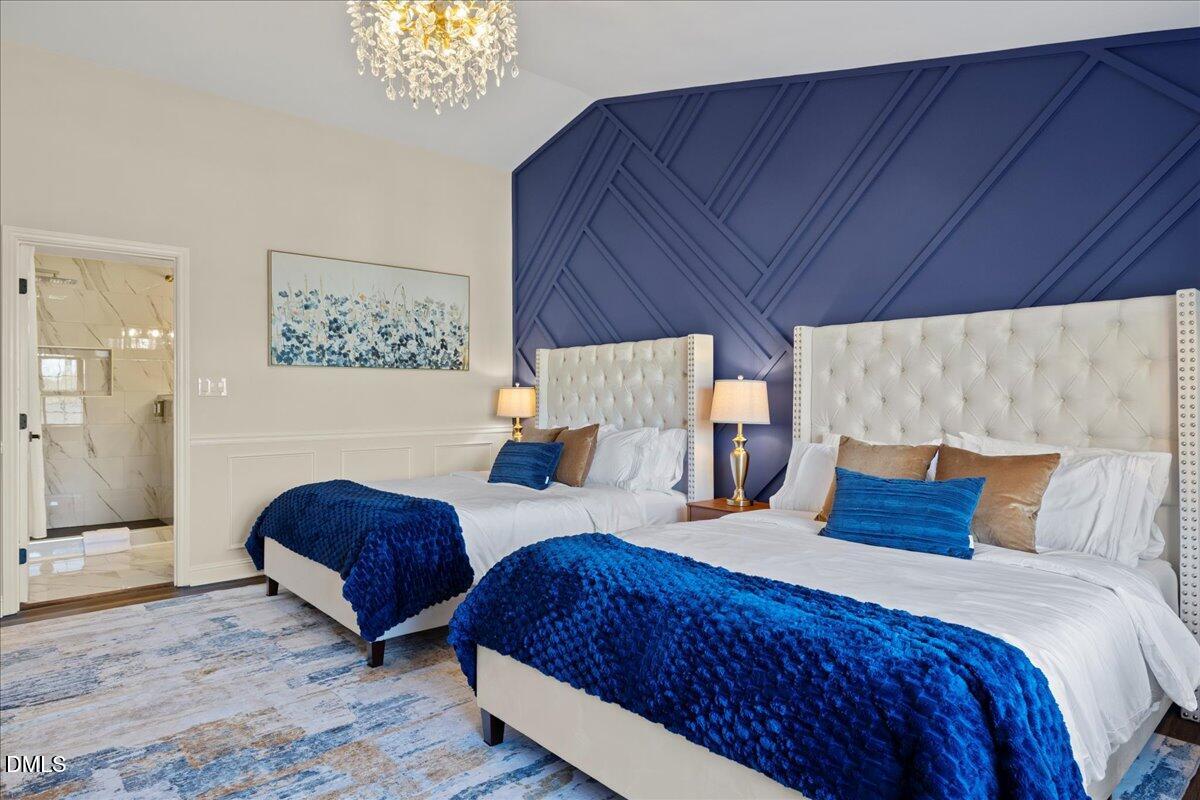 300 Pate Street Apex, NC 27502 - Photo 35 of 57 a bedroom with bed and a chandelier