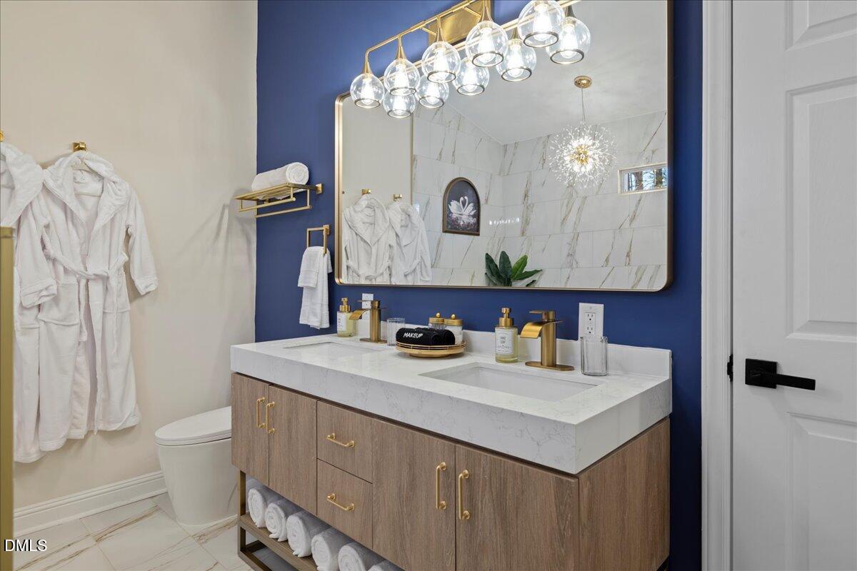 300 Pate Street Apex, NC 27502 - Photo 37 of 57 a bathroom with a sink vanity mirror and toilet