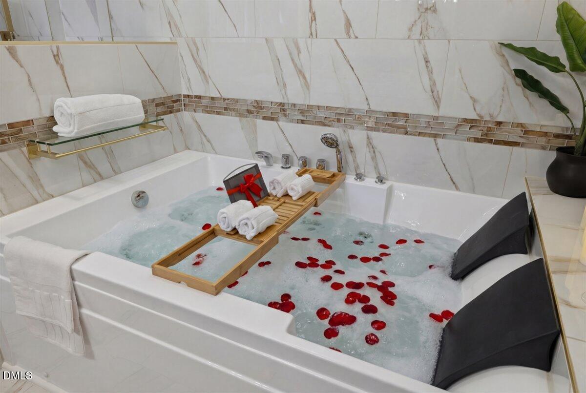 300 Pate Street Apex, NC 27502 - Photo 39 of 57 a white bath tub sitting next to a white wall