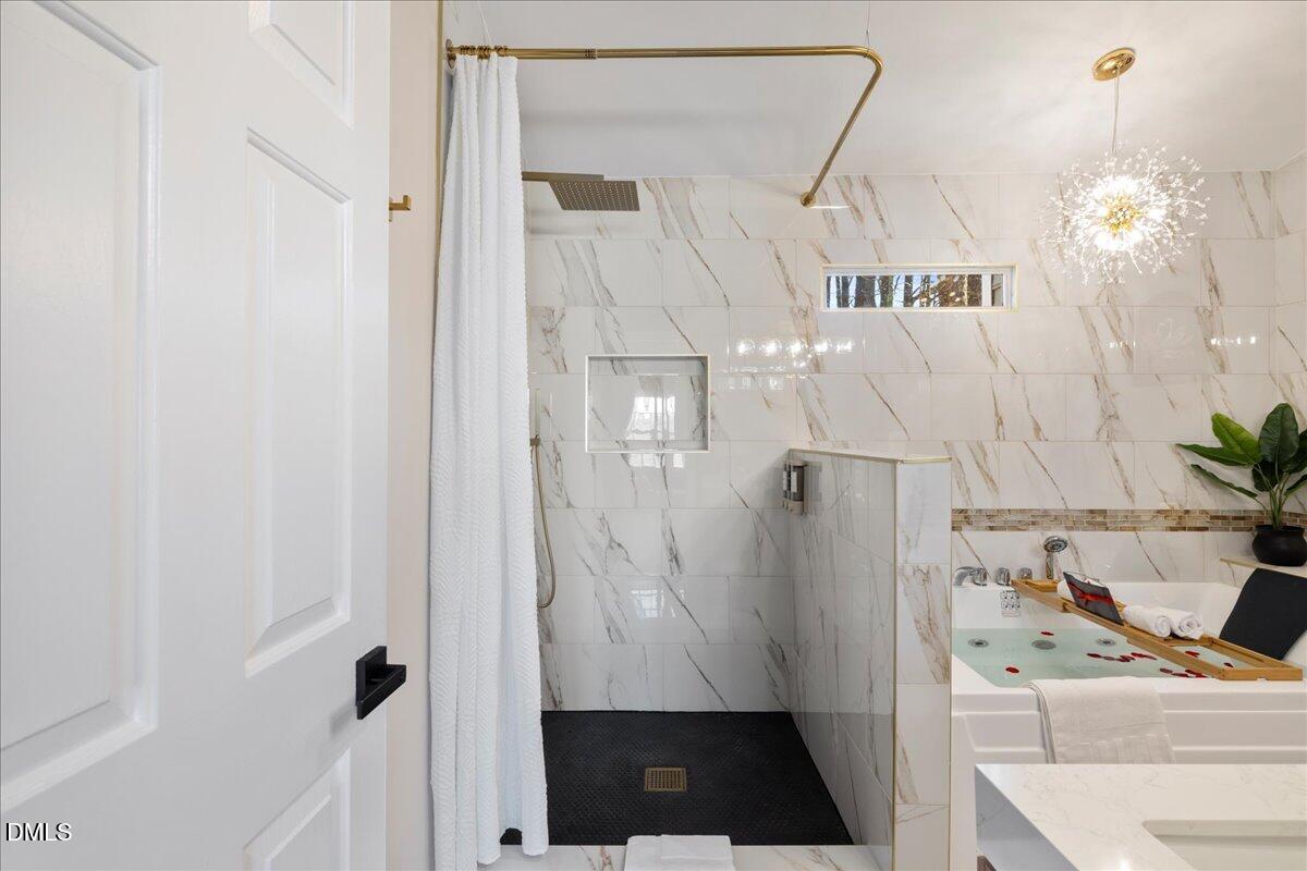 300 Pate Street Apex, NC 27502 - Photo 41 of 57 a view of a hallway with furniture and a chandelier