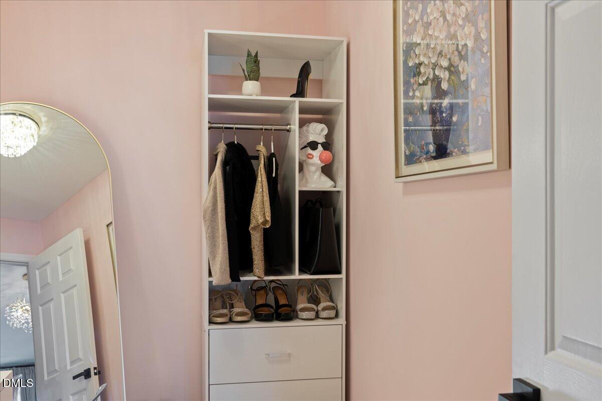 300 Pate Street Apex, NC 27502 - Photo 44 of 57 a view of walk in closet with clothes and shoes