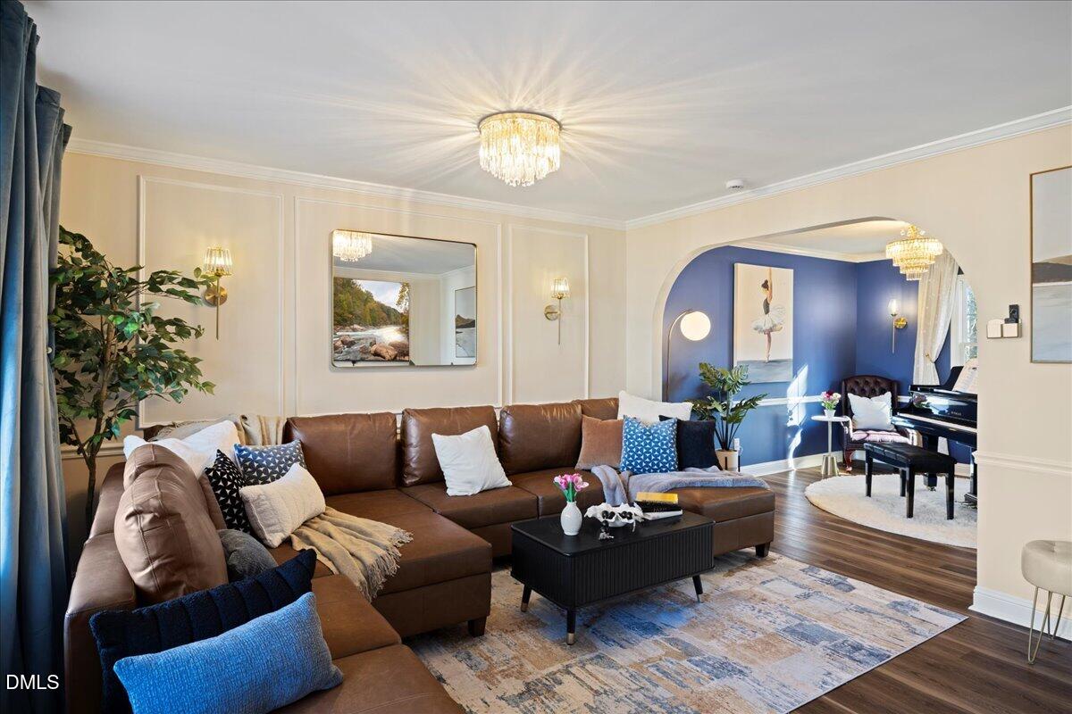 300 Pate Street Apex, NC 27502 - Photo 5 of 57 a living room with furniture and a chandelier