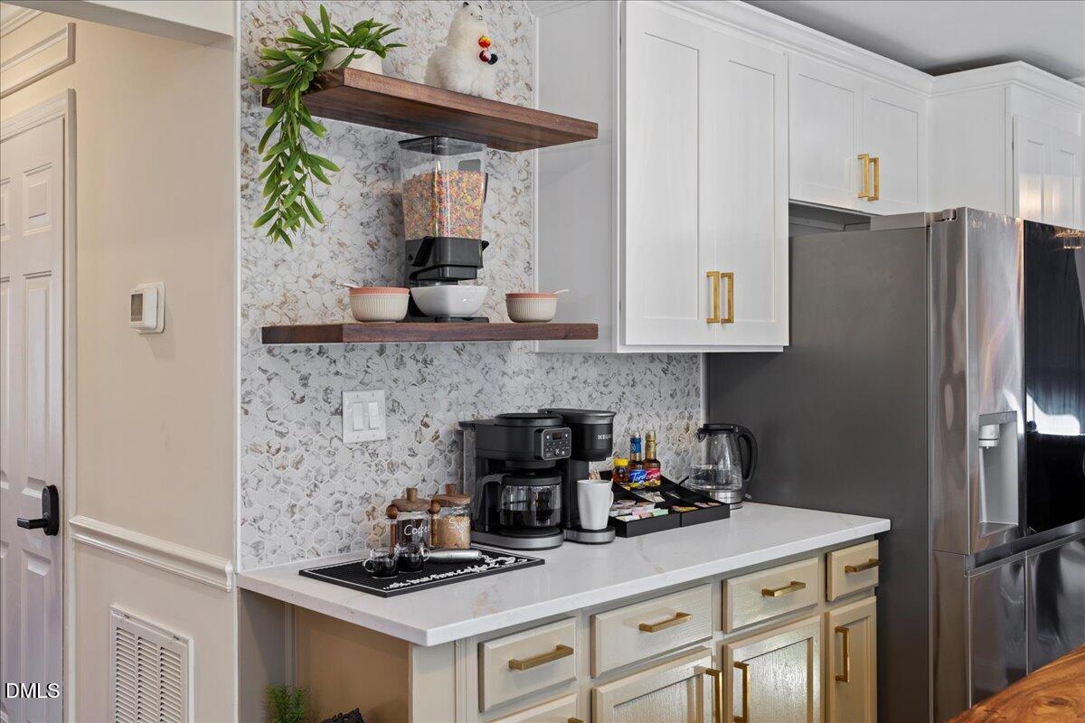 300 Pate Street Apex, NC 27502 - Photo 8 of 57 a kitchen with a refrigerator and a stove