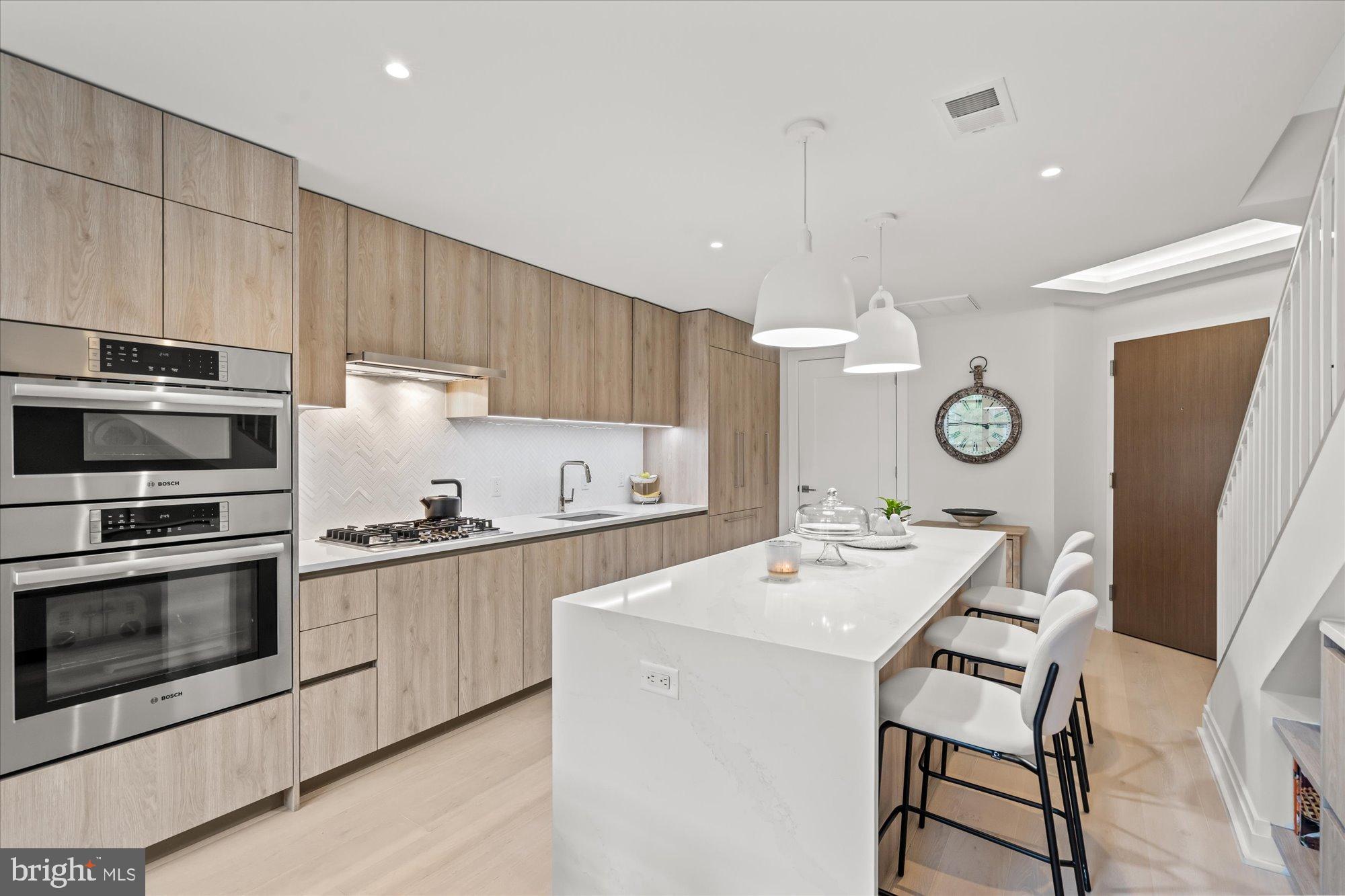 1201 North Royal Street, Unit 214 Alexandria, VA 22314 - Photo 13 of 71 a kitchen with a sink stainless steel appliances and cabinets