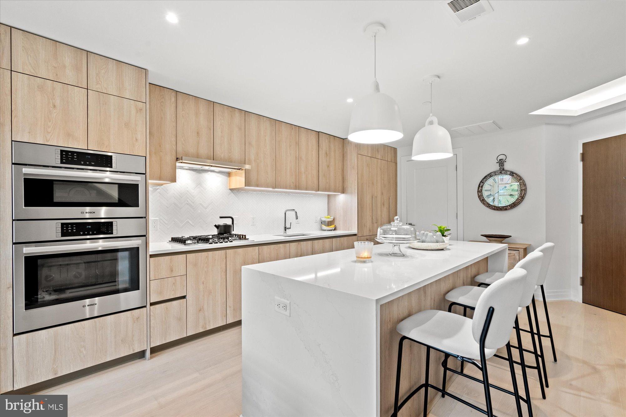 1201 North Royal Street, Unit 214 Alexandria, VA 22314 - Photo 20 of 71 a kitchen with a stove a sink and a microwave