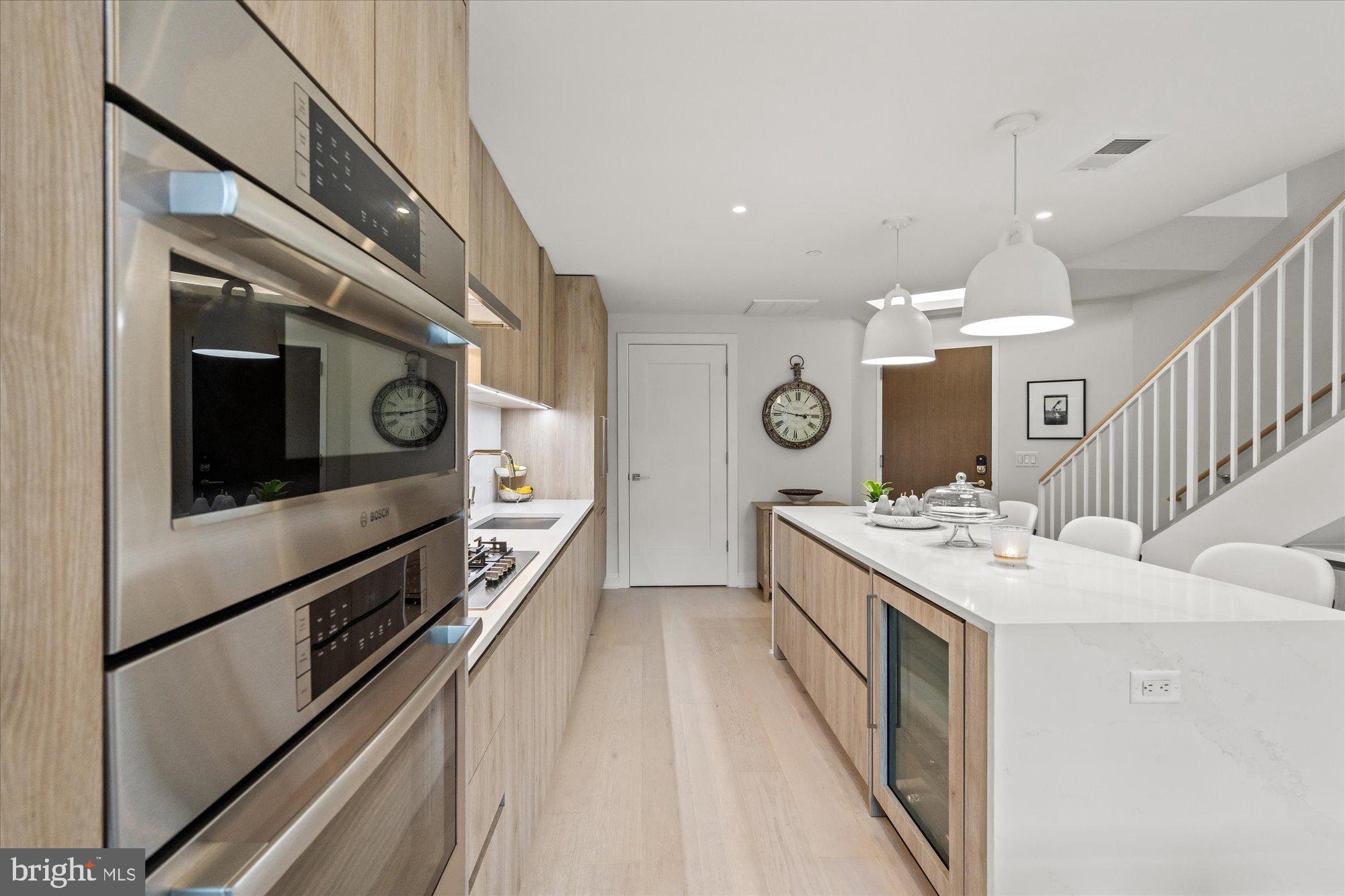 1201 North Royal Street, Unit 214 Alexandria, VA 22314 - Photo 21 of 71 a kitchen with stainless steel appliances granite countertop a kitchen island a stove and a sink