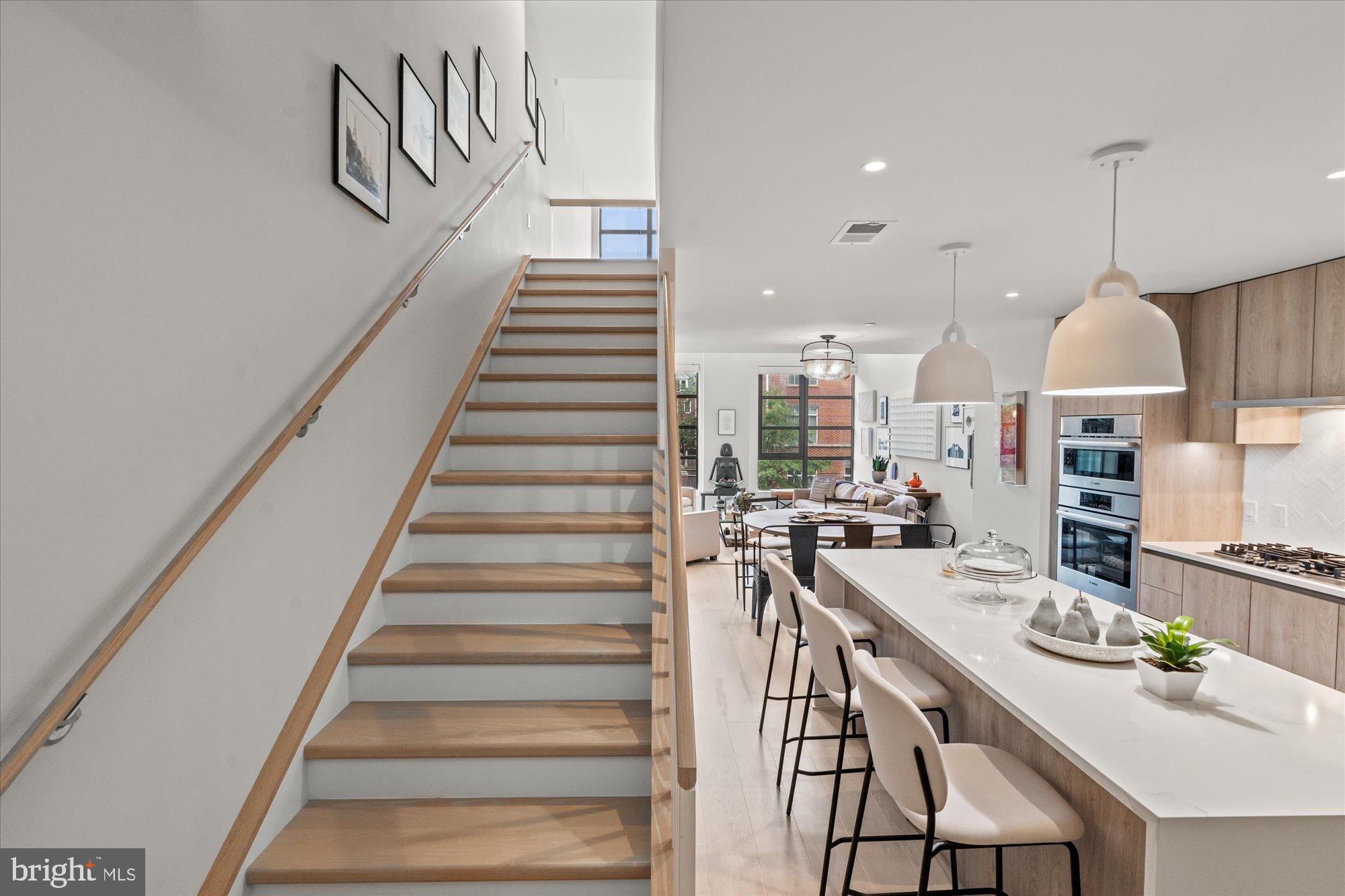 1201 North Royal Street, Unit 214 Alexandria, VA 22314 - Photo 22 of 71 a view of a kitchen with furniture and wooden floor