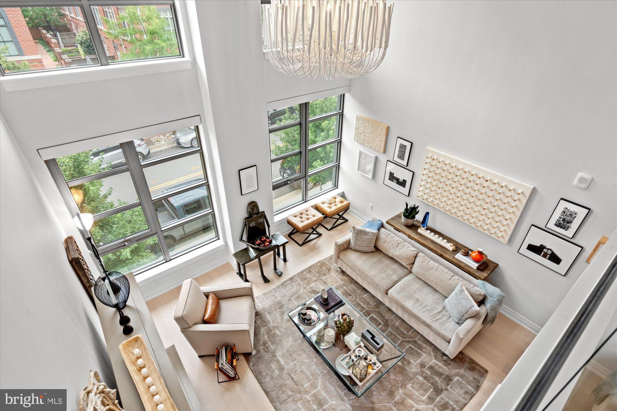 1201 North Royal Street, Unit 214 Alexandria, VA 22314 - Photo 23 of 71 a living room with furniture and a floor to ceiling window
