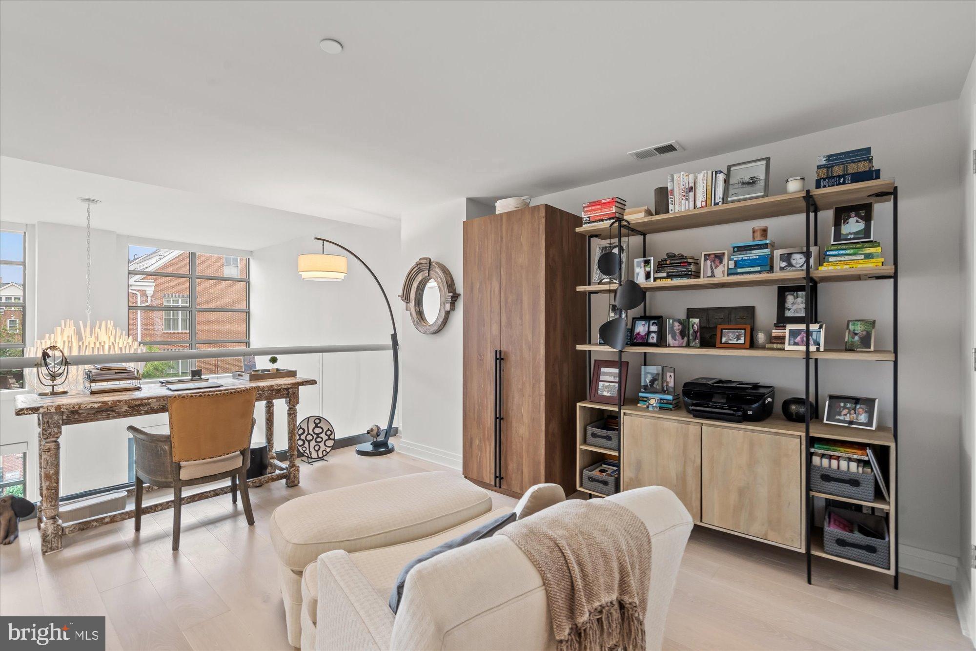 1201 North Royal Street, Unit 214 Alexandria, VA 22314 - Photo 26 of 71 a living room with furniture and a book shelf