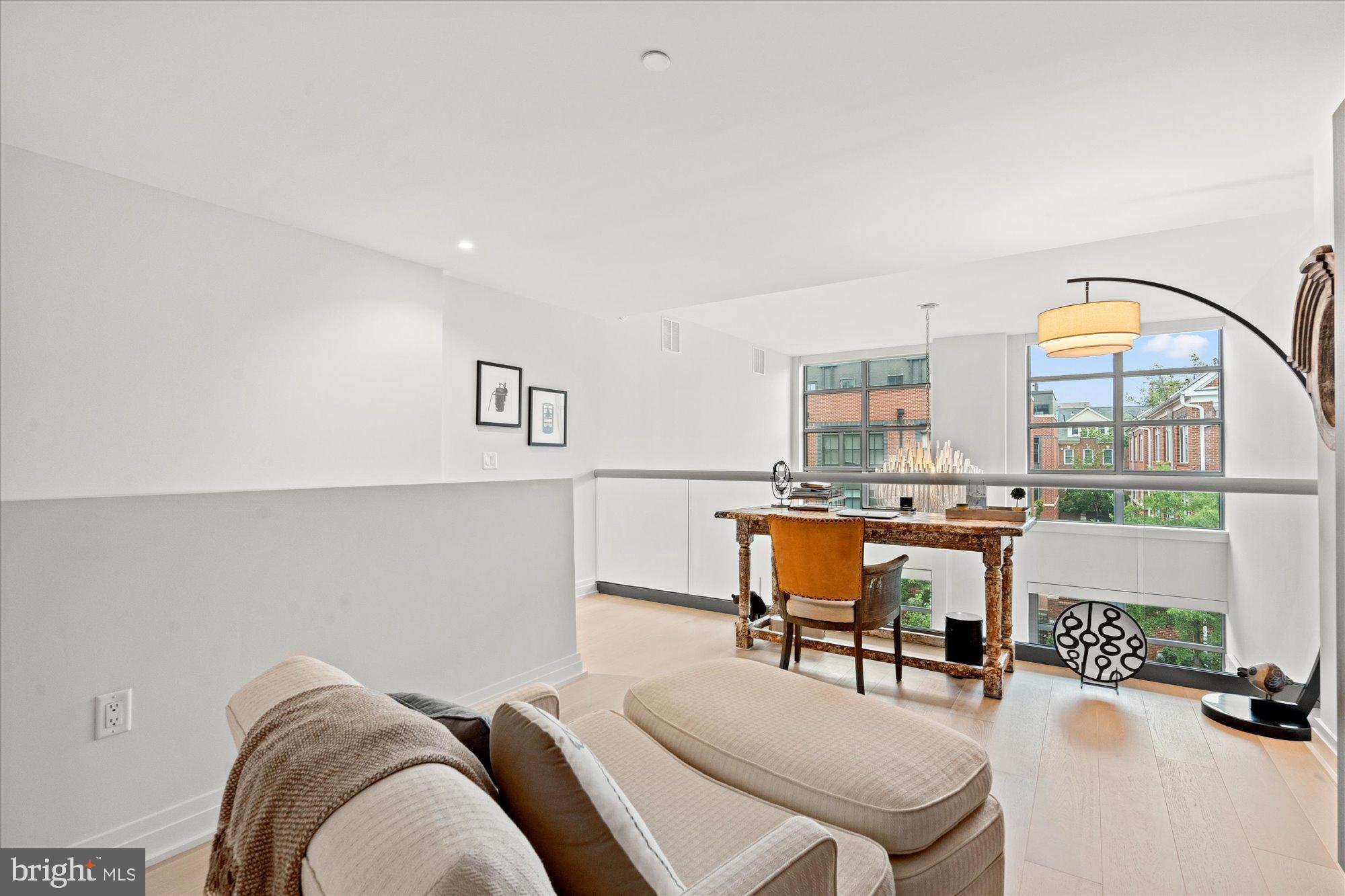 1201 North Royal Street, Unit 214 Alexandria, VA 22314 - Photo 27 of 71 a living room with furniture and floor to ceiling windows