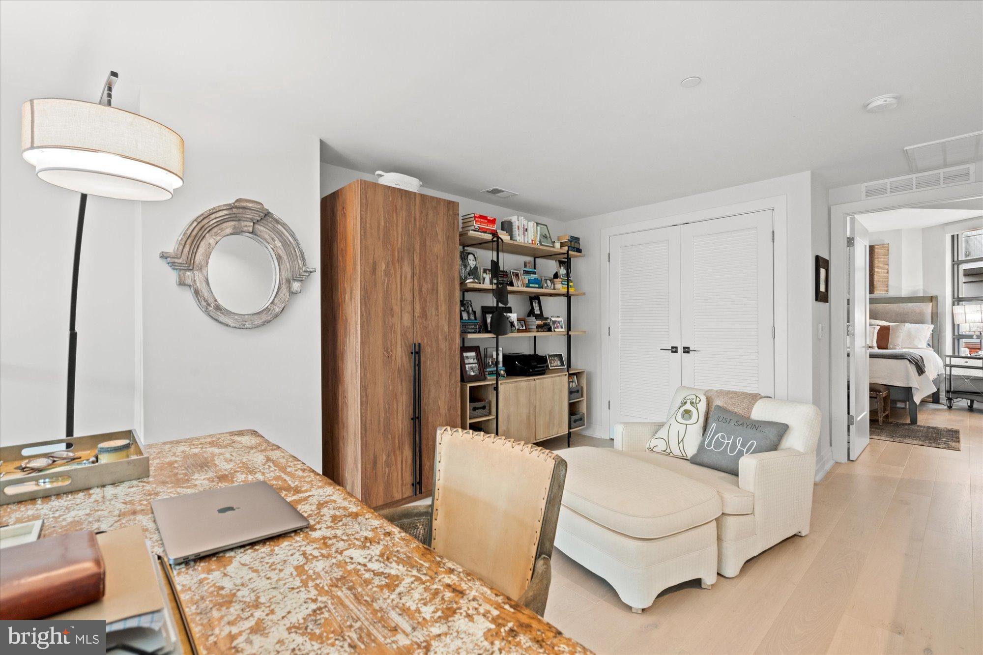1201 North Royal Street, Unit 214 Alexandria, VA 22314 - Photo 28 of 71 a living room with furniture a rug and white walls