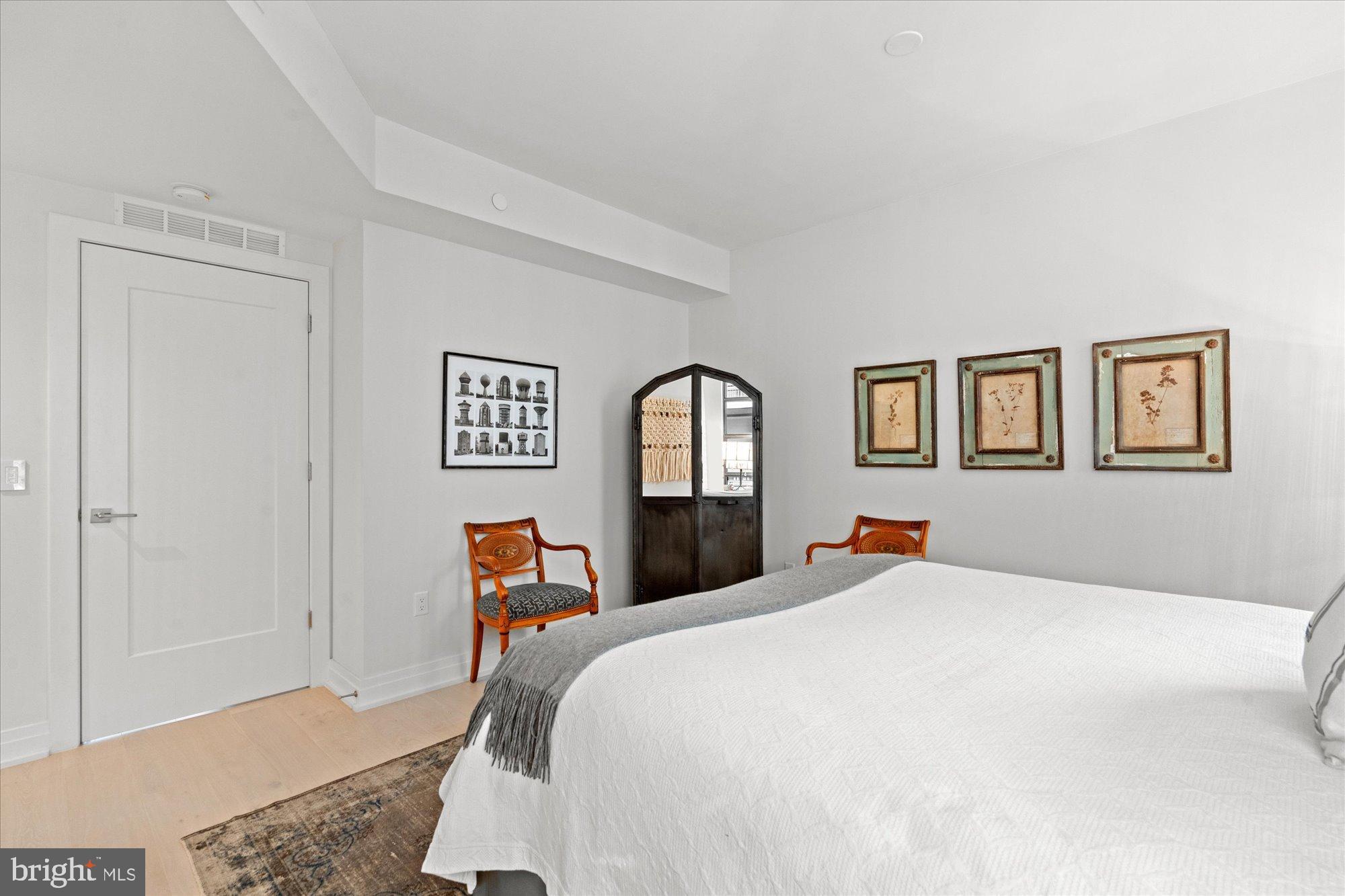 1201 North Royal Street, Unit 214 Alexandria, VA 22314 - Photo 35 of 71 Serene bedroom with elegant decor accents.