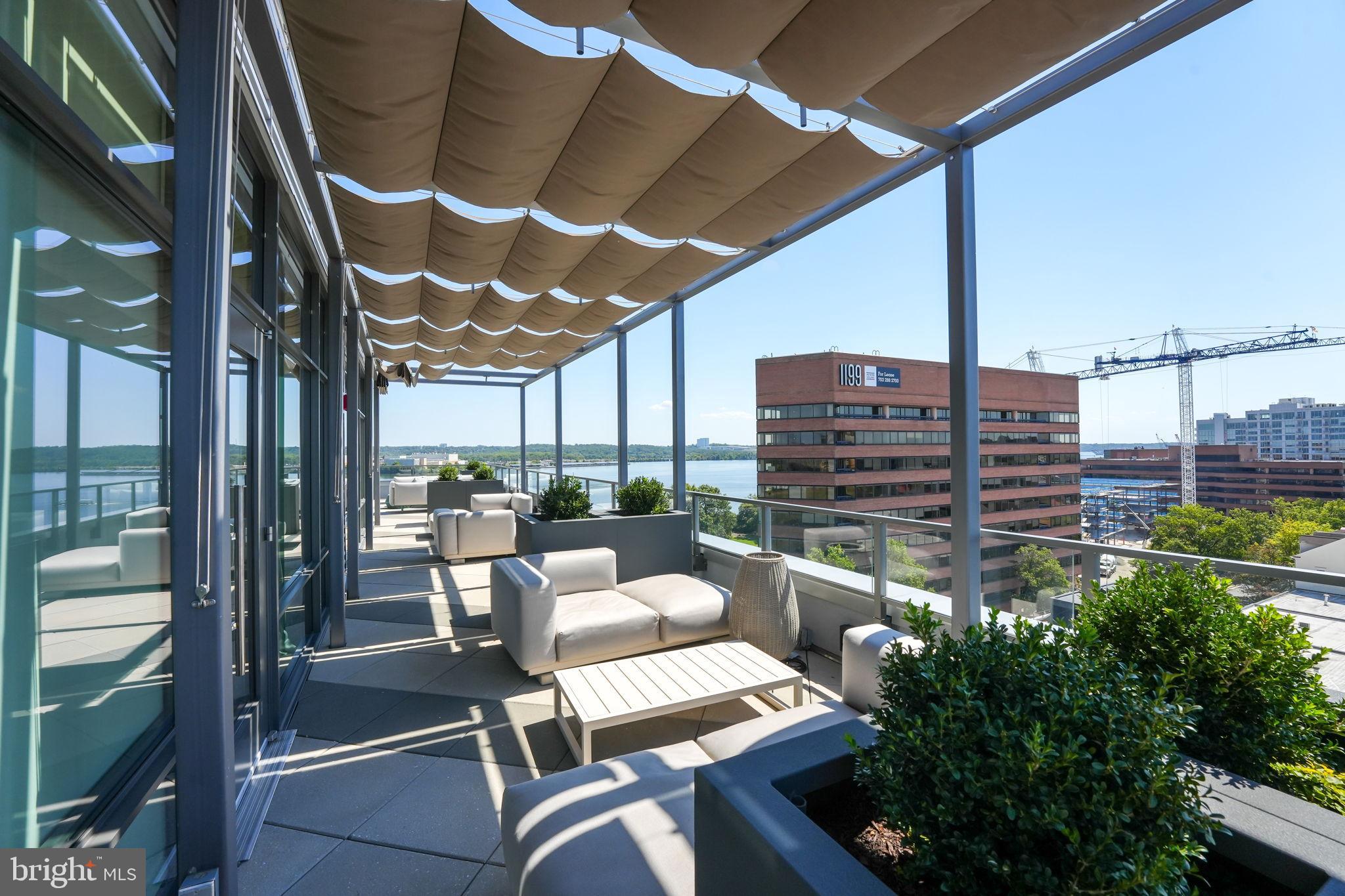 1201 North Royal Street, Unit 214 Alexandria, VA 22314 - Photo 43 of 71 a view of a balcony with chairs and a potted plant